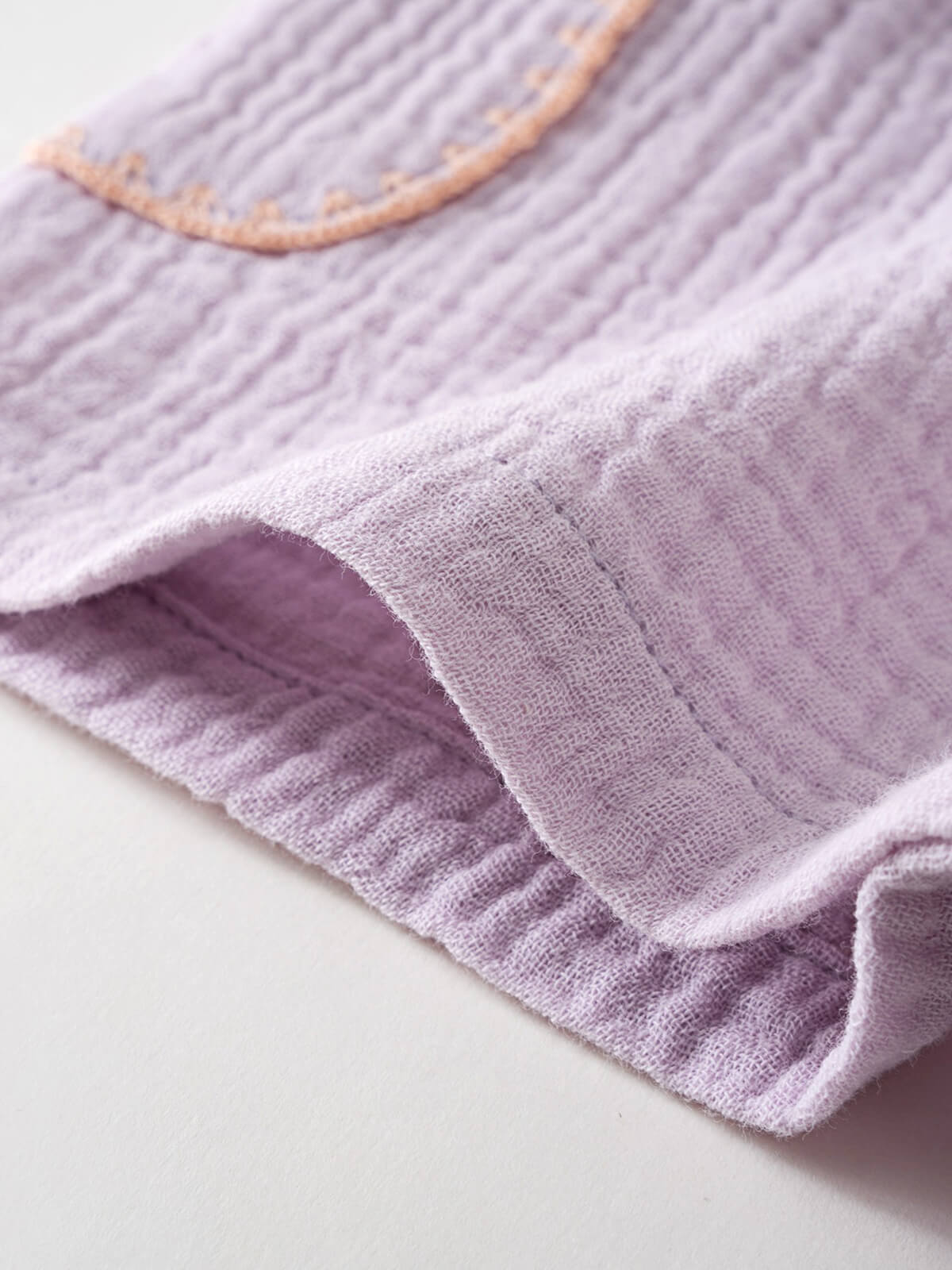 Close-up of lilac textured fabric shorts with elastic waistband and yellow trim Muslin Shorts - Lilac Girls
