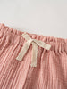 Close-up of pink crinkled cotton shorts with cream drawstring tie Muslin Shorts - Toasted Peach Girls
