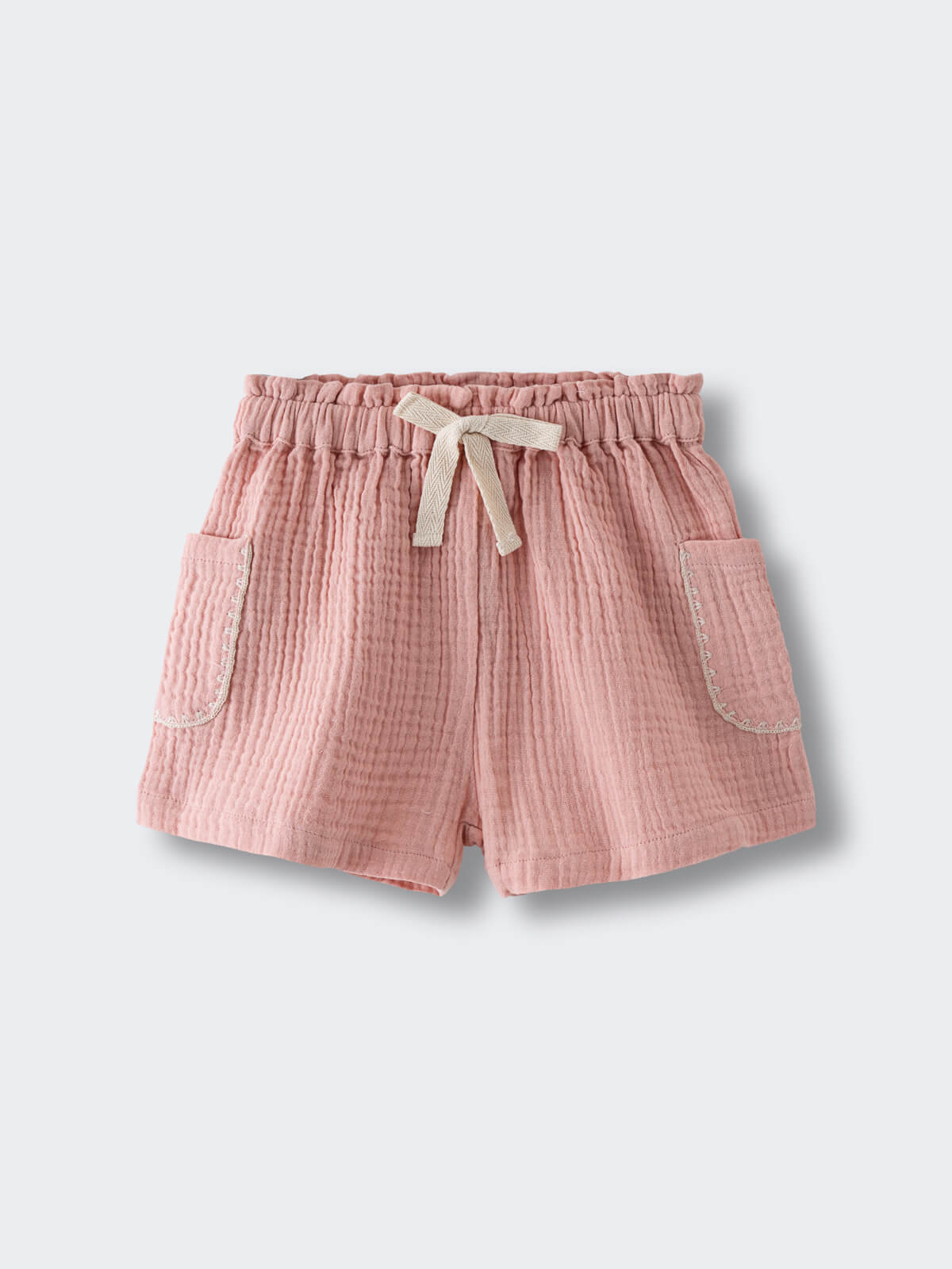 Pink textured shorts with drawstring waist and patch pockets on white background Muslin Shorts - Toasted Peach Girls