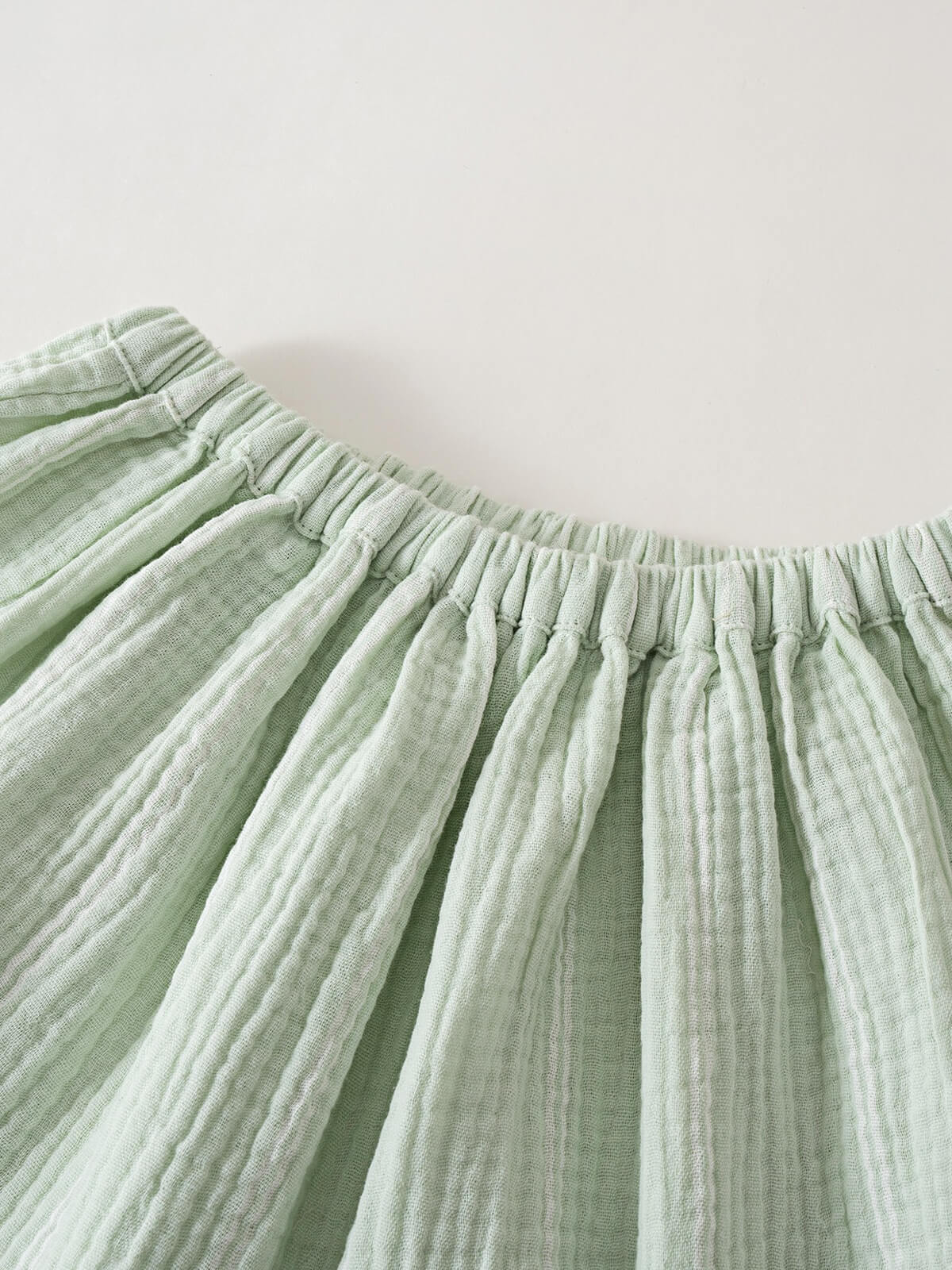 Close-up of light green striped gathered skirt waistband with elastic Muslin Skirt - Light Green Stripe Girls