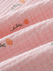 Close-up of pink fabric with small orange flowers and green leaf pattern Muslin Top - Poppy Field Girls