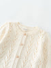 Cream-colored cardigan with button details on a light gray background Pointelle Cardigan - Ecru Girls