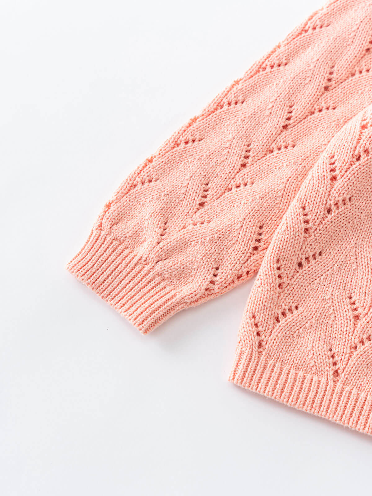 Close-up of pink cardigan with cable knit pattern on a white background Pointelle Cardigan - Mallow Girls