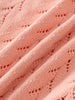 Close-up of Pink cardigan with cable knit pattern fabric with a subtle pattern Pointelle Cardigan - Mallow Girls