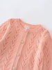 Pink cardigan with cable knit pattern with button details on a light gray background Pointelle Cardigan - Mallow Girls