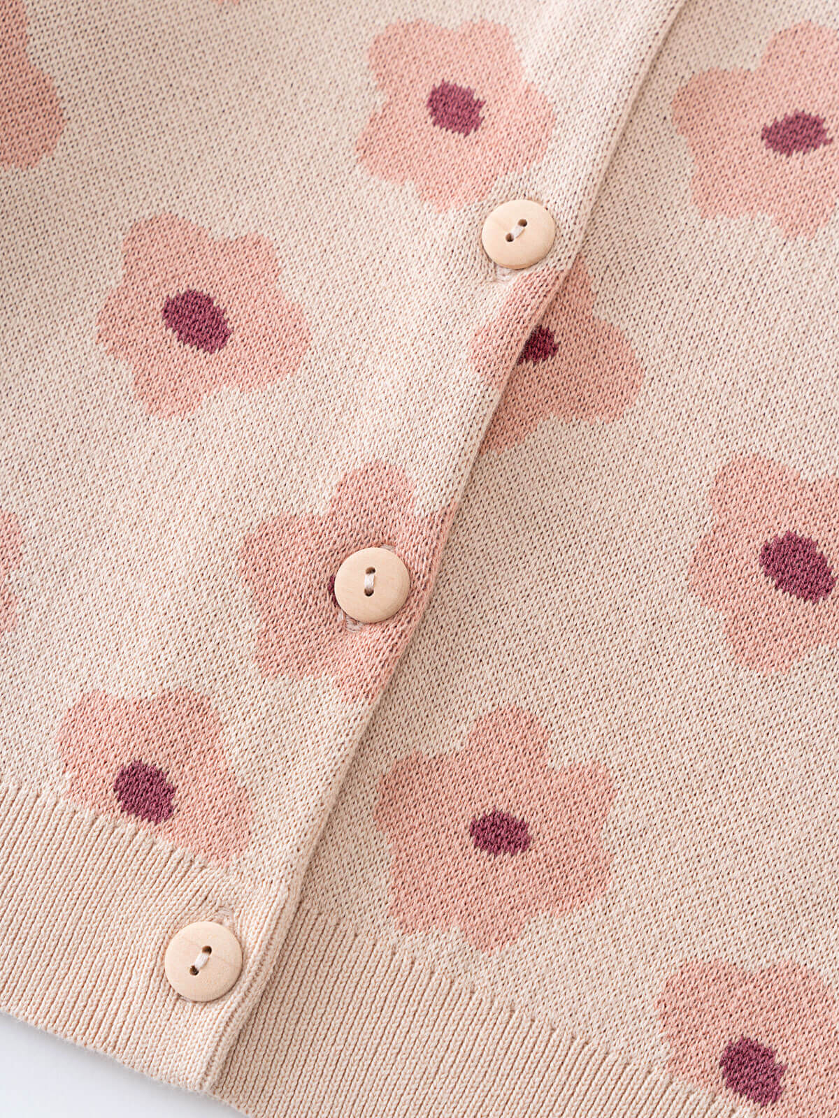 Close-up of a pink cardigan with floral patterns and buttons on a light background Printed Cardigan - Bold Daisy Girls
