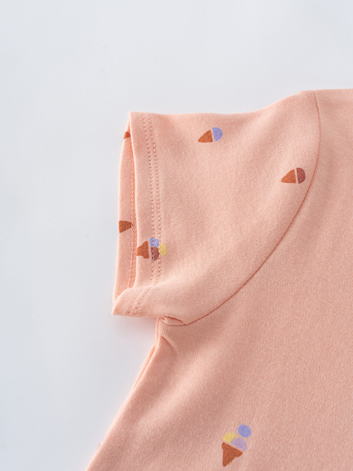 Close-up of peach fabric with small ice cream cone print details Printed Short Sleeve Tee Shirt - Ice Creams Girls