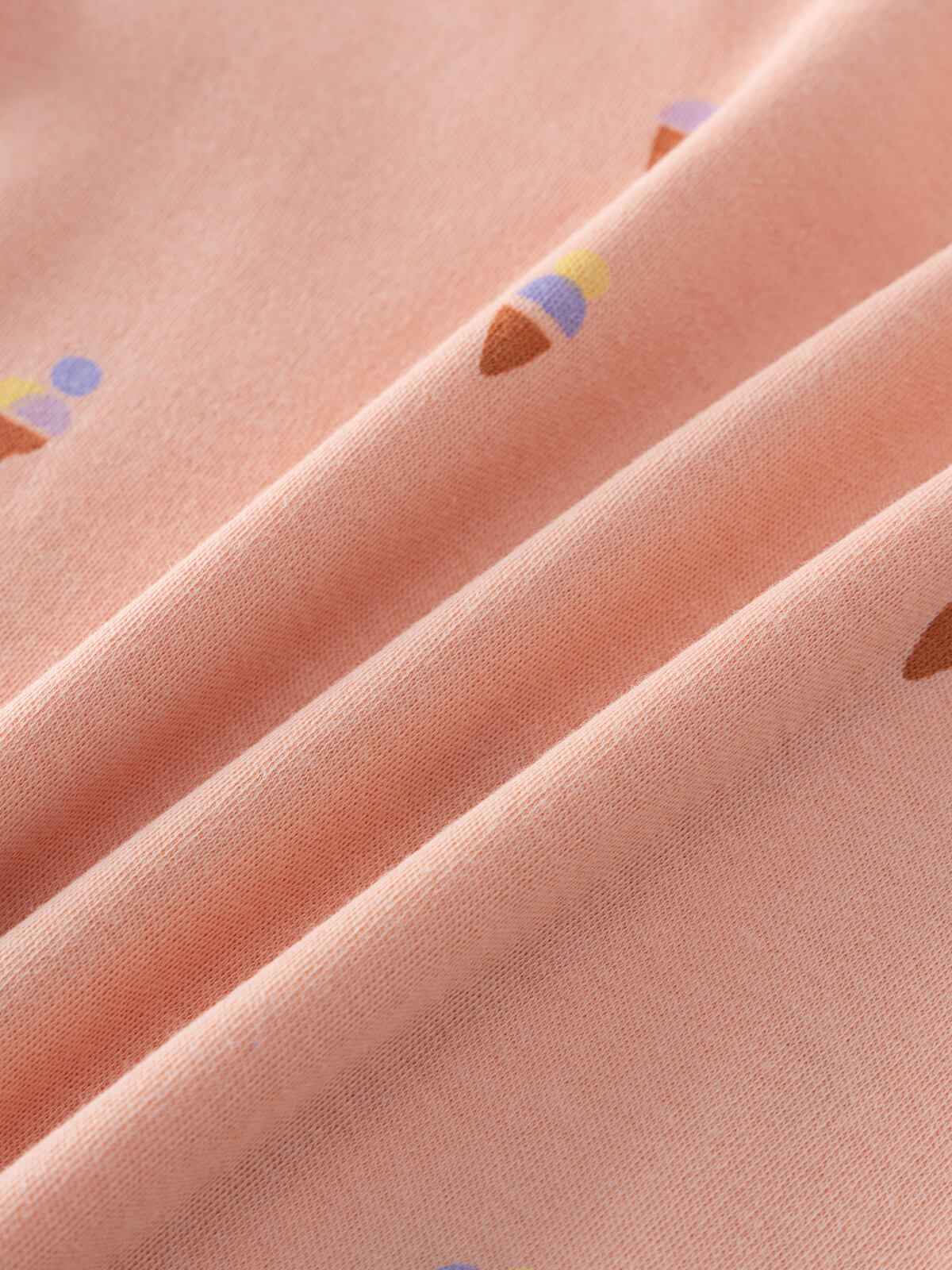 Close-up of peach fabric with small ice cream cone print details Printed Short Sleeve Tee Shirt - Ice Creams Girls