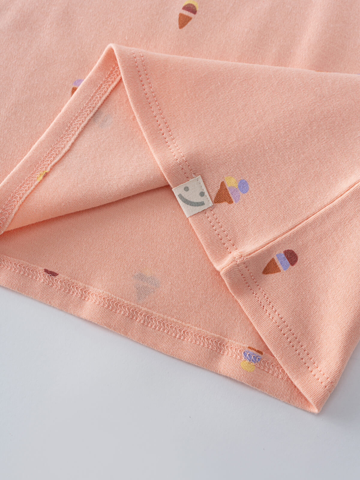 Close-up of pink fabric with colorful ice cream cone embroidery and visible stitching Printed Short Sleeve Tee Shirt - Ice Creams Girls