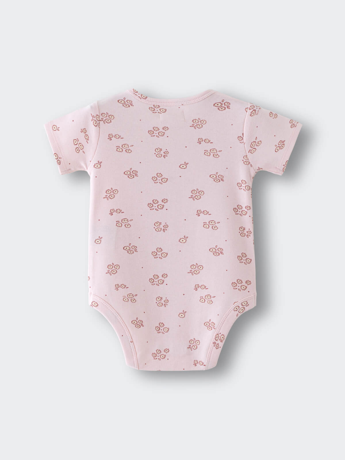 Pink baby bodysuit with small floral pattern laid flat on surface Printed Short Sleeve Bodysuit - Daisy Chain Baby girl