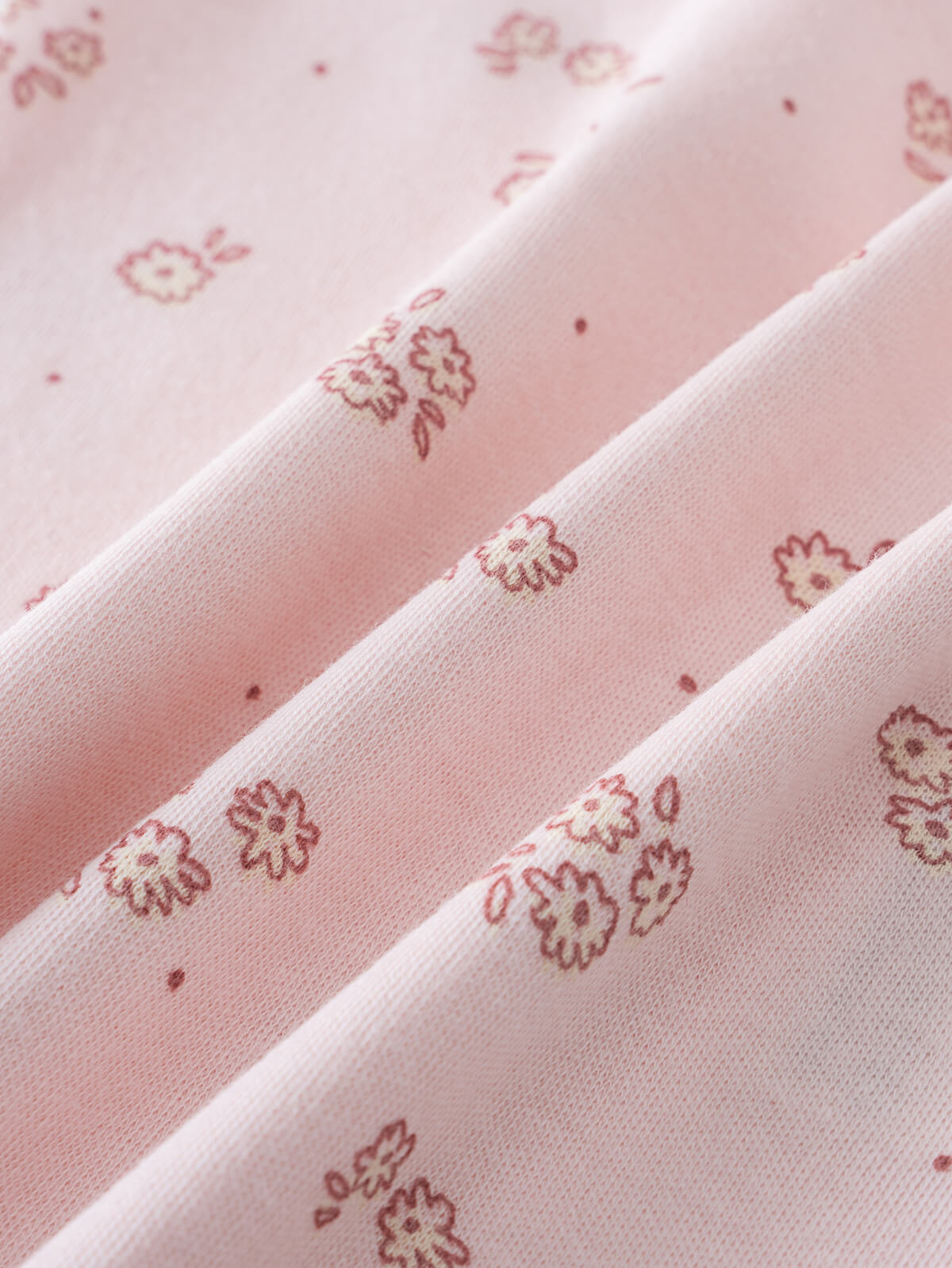 Close-up of pink fabric with small floral print pattern Printed Short Sleeve Bodysuit - Daisy Chain Baby girl