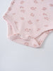 Close-up of pink baby bodysuit with floral print and snap closures Printed Short Sleeve Bodysuit - Daisy Chain Baby girl