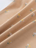 Close-up of peach fabric with small floral print pattern Printed Short Sleeve Bodysuit - Floral Bloom Baby girl
