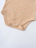Close-up of a beige onesie with small floral print and snap closures Printed Short Sleeve Bodysuit - Floral Bloom Baby girl
