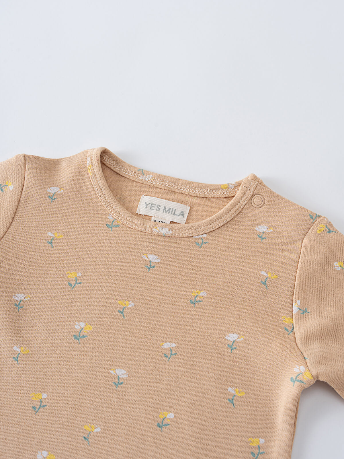 Close-up of a beige bodysuit with small floral pattern print Printed Short Sleeve Bodysuit - Floral Bloom Baby girl
