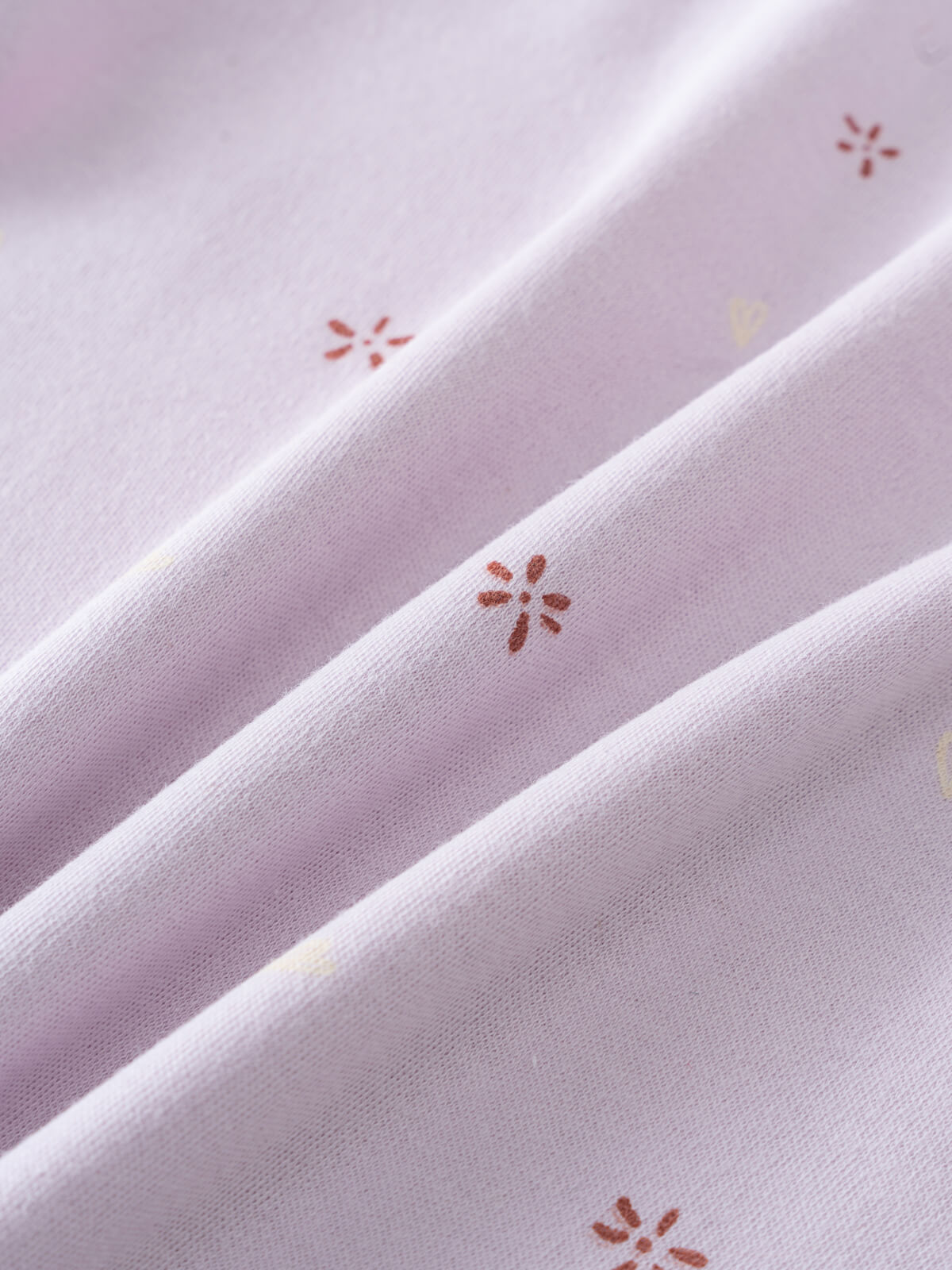 Close-up of light purple fabric with small red floral embroidered details printed Short Sleeve Tee Shirt - Spring Love Girls