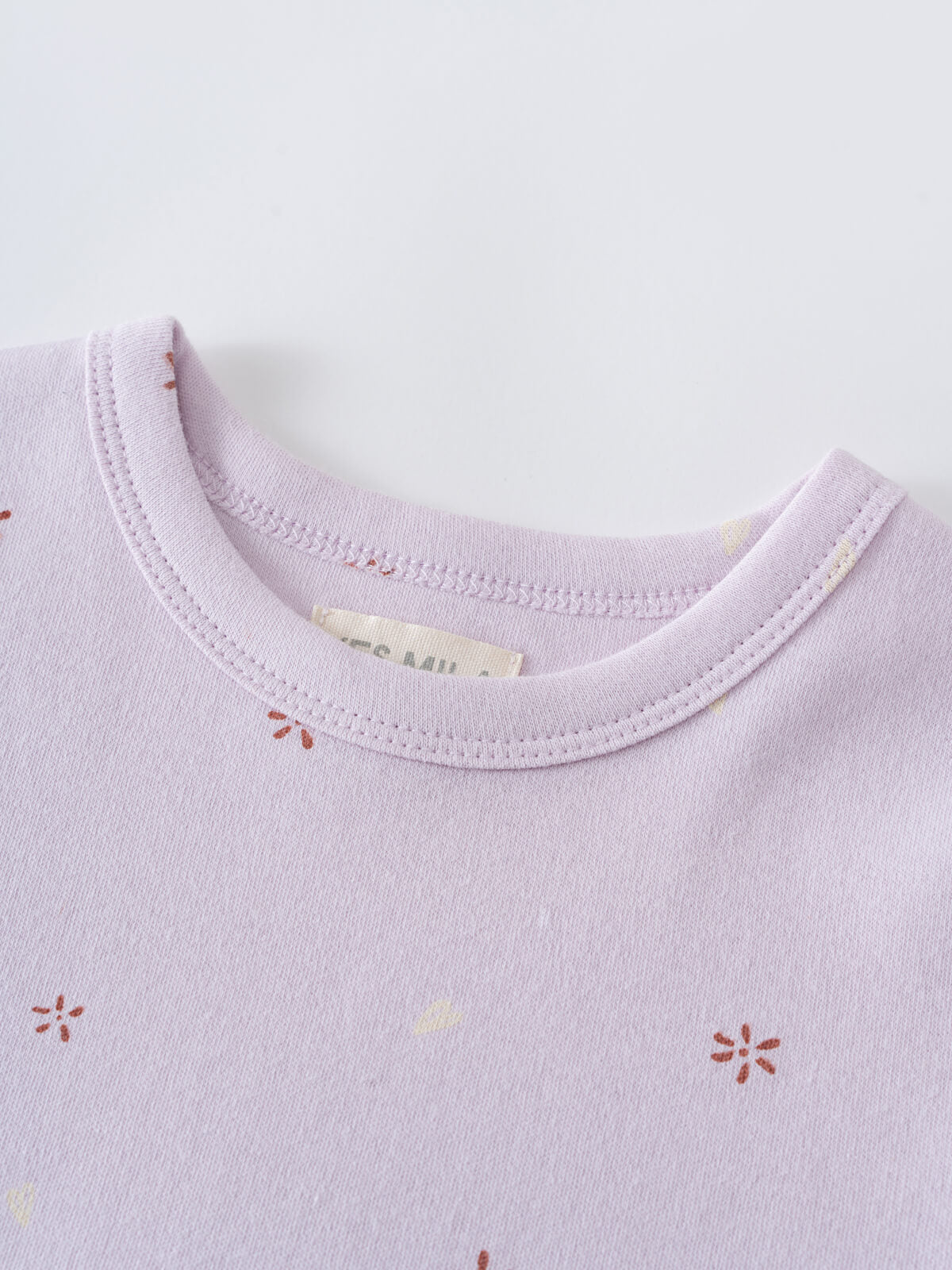 Close-up of a lavender t-shirt neckline with small floral embroidery details printed Short Sleeve Tee Shirt - Spring Love Girls