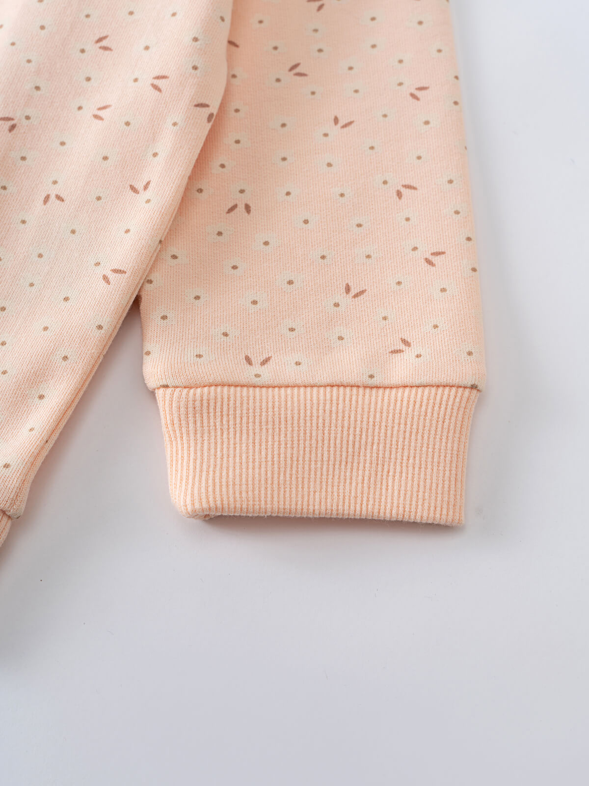 Close-up of peach sweatshirt sleeve with dotted pattern and ribbed cuff printed Sweatshirt - Flower Power Girls
