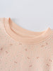 Close-up of a peach ribbed neckline on a speckled sweatshirt printed Sweatshirt - Flower Power Girls