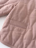 Close-up of a quilted pink jacket with stitching details on a white background Quilted Jacket - Blush Baby girl