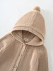 Beige knitted cardigan with hood and pompom laid flat on white surface Ribbed Hooded Cardigan - Clay Baby boy