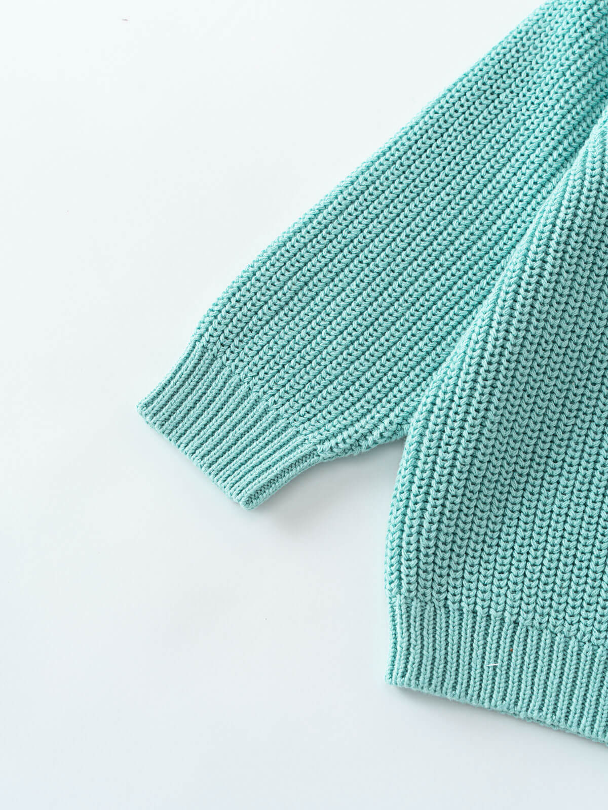 Close-up of a light blue knitted fabric on a white background