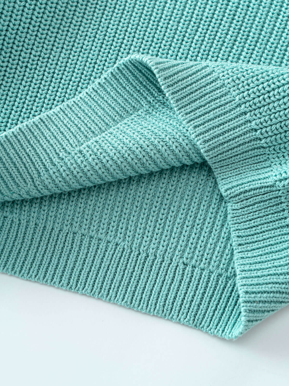 Lake blue sweater on a light blue background