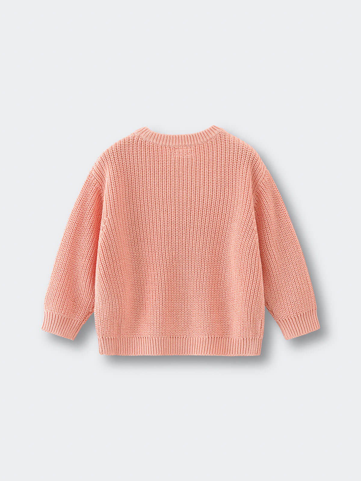 Pink knitted sweater on a light gray background