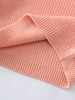 Close-up of a pink knitted fabric on a light gray background