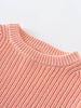 Close-up of a pink knitted sweater on a light gray background