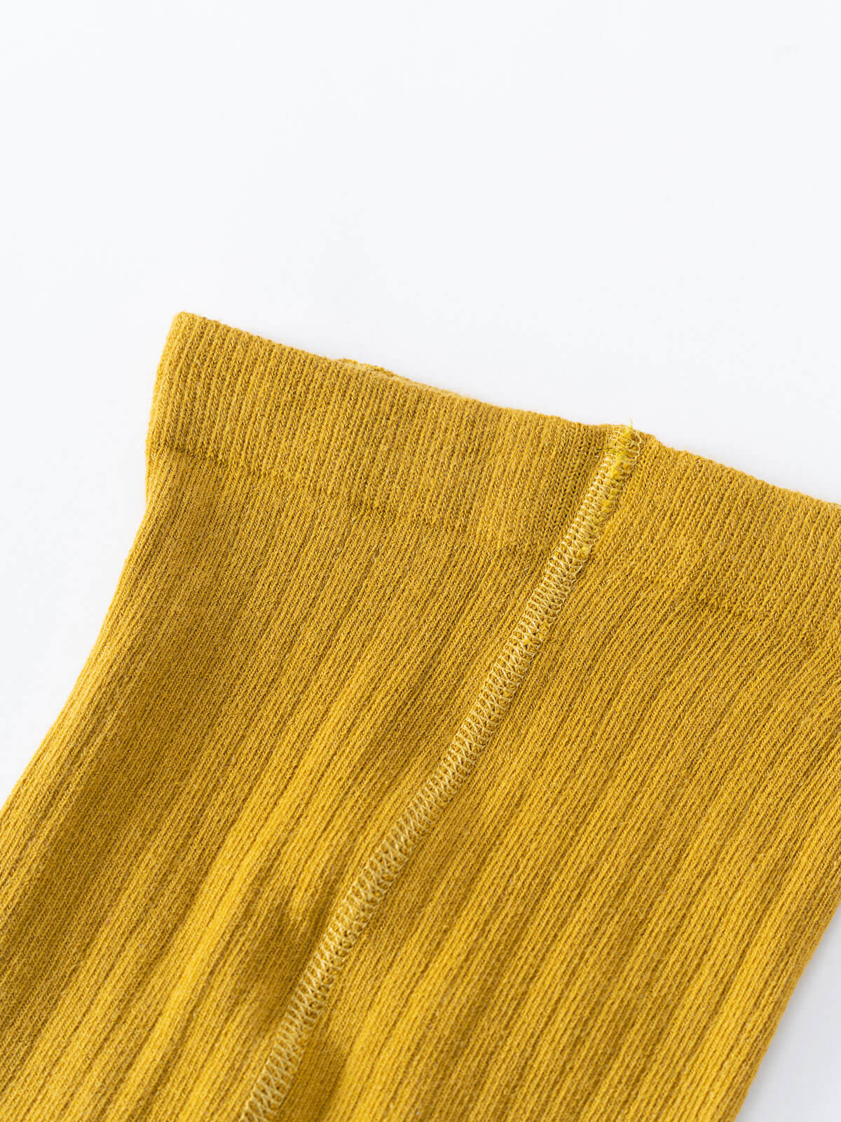 Close-up of mustard yellow ribbed fabric with visible seam detail Ribbed Tights 2 Pack - Golden Pear/Ecru Girls