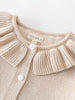 Beige knitted cardigan with a ruffled collar and visible 'YES MILA' label on a light background. Ruffle Cardigan - Ecru Girls