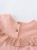 Close-up of a pink blouse with a lace collar and buttons on a light gray background Ruffle Top - Mallow Girls