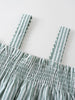 Close-up of green and white striped fabric with smocked detail and scalloped straps Shirred Top - Mint Stripe Girls