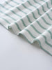 Close-up of white fabric with sage green curved stripes, shown folded Short Sleeve Dress - Harbour Stripe Girls