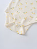 Close-up of cream baby bodysuit with yellow lemon print and snap closures Sleeveless Bodysuit - Lemons Baby girl
