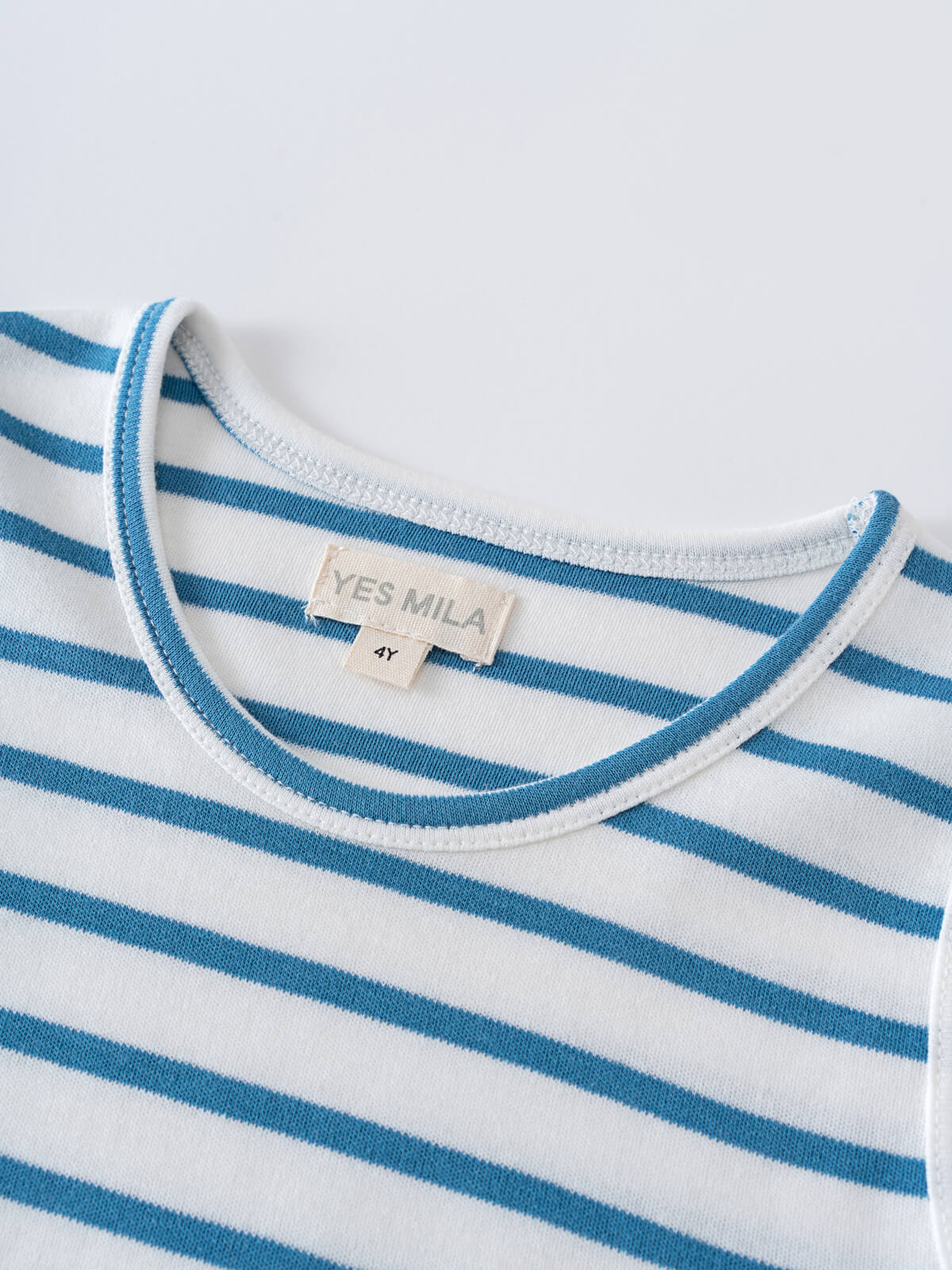 Close-up of a blue and white striped shirt neckline with label Sleeveless Tee - Blue Stripe Boys