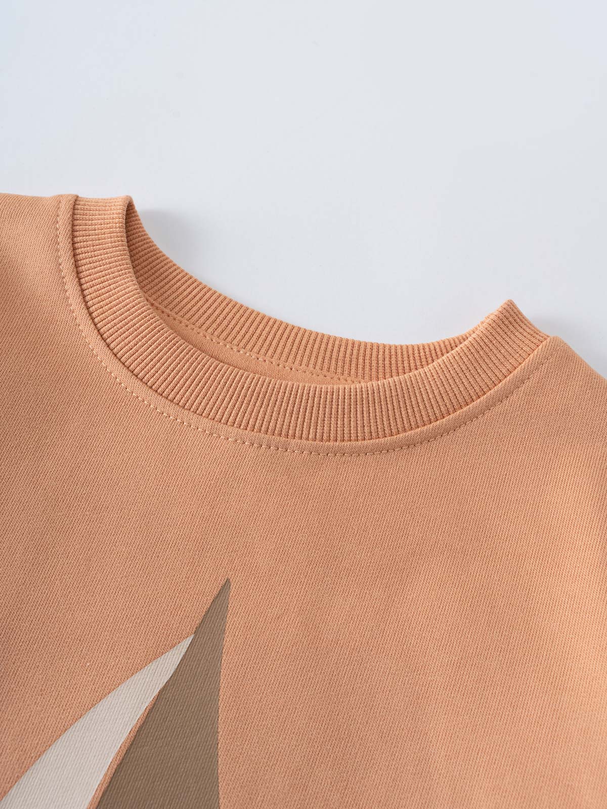 Close-up of a peach sweatshirt neckline with geometric sailboat design Sweatshirt - Yes Sailing Boys