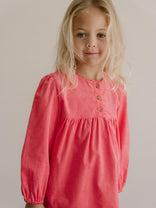 Young girl wearing a pink dress with long sleeves against a plain background Three Button Blouse - Cloudberry Girls