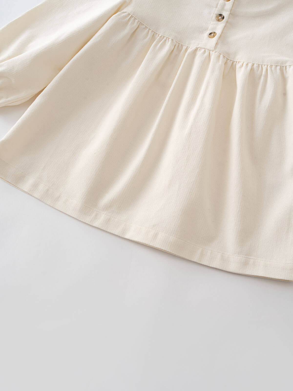 Close-up of a cream-colored blouse with buttons with a plain background Three Button Blouse - Ecru Girls