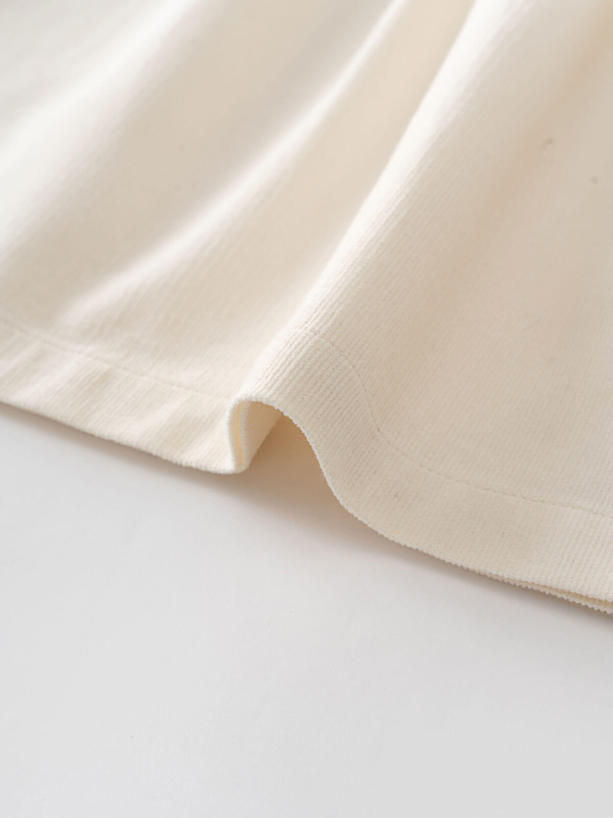 Close-up of a beige fabric on a light gray background Three Button Blouse - Ecru Girls