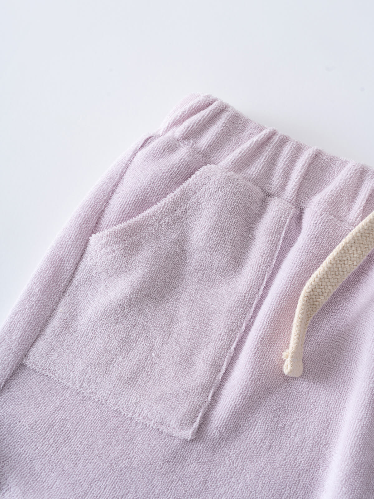 Close-up of lilac towelling shorts with pocket and cream drawstring waistband Towelling Shorts - Lilac Girls