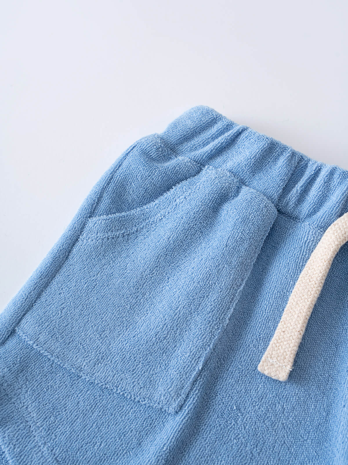 Close-up of blue towelling shorts with beige drawstring detail Towelling Shorts - Sky Blue Boys